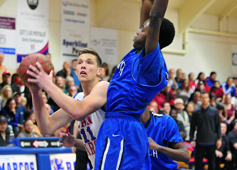 Scott Everman looks to score while being pressured by a Diamond Ranch defender. Everman led the Royals with 11 points.