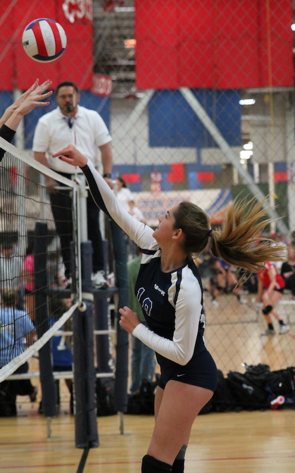 Sophie Breathed of the SBVC 15-Blue team swings past the block.