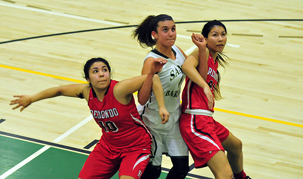Redondo players Micaela Enriquez, left, and Elise Allison try to keep Amber Melgoza off the boards.