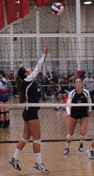 Allie Sundara of the Santa Barbara Volleyball Club's 18-Blue team sets the ball as teammate Natalie Klapp looks on.