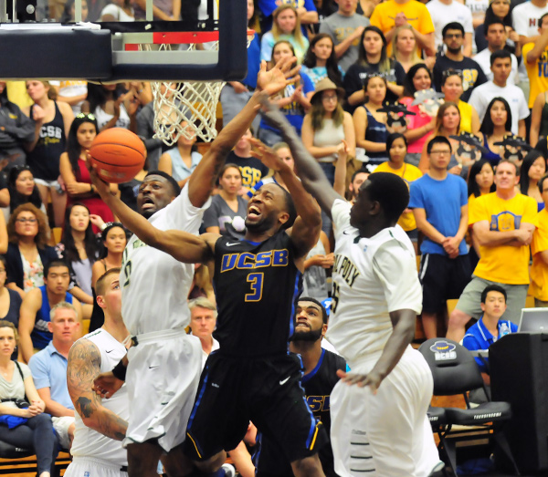 UCSB's Zalmico Harmon gets to the rim, splitting Cal Poly defenders David Nwaba, left, and Joel Awich, right.