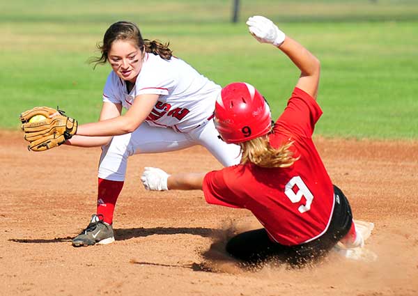 Carpinteria's Scarlett Pettine slides safely into second base ahead of the tag by Bishop Diego shortstop Marissa Cordero.