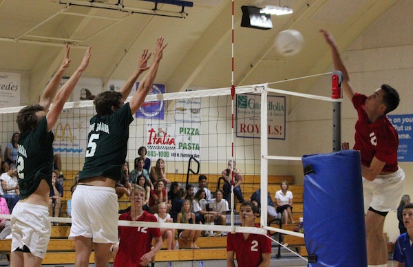 Connor Everman of San Marcos hits against the Santa Barbara block of Cord Pereira (5) and JM Cage. Everman led the Royals' attack with 23 kills.