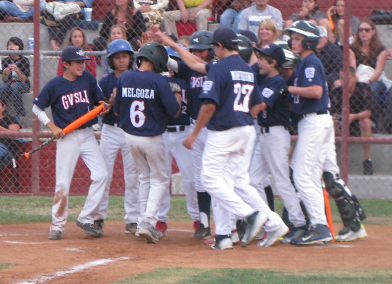 Buddy Melgoza is mobbed by his Goleta Valley South All-Star teammates after belting a grand slam in the first inning of Wednesday’s 18-1 win.