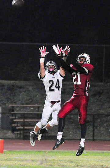 Brandon Jordan and Austen Paulicano leap for the ball that gets tipped into the air before Jordan brings it down for a TD.