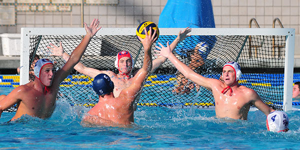 The San Marcos defense, Miles Cole on the left, goalie Jack Palmer in the middle, and Adam Fuller, right, defends a shot by Dos Pueblos' Taylor Gustason. (John Dvorak/Presidio Sports Photos)