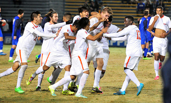 Fullerton celebrates with goal-scorer in the middle. (John Dvorak/Presidio Sports Photos)